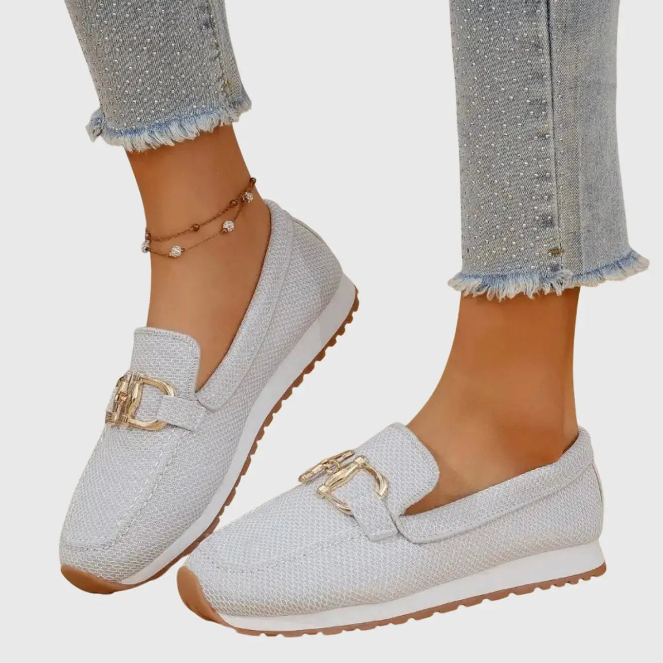View of beige slip on loafers made from soft suede, featuring a sleek silhouette and subtle stitching accents