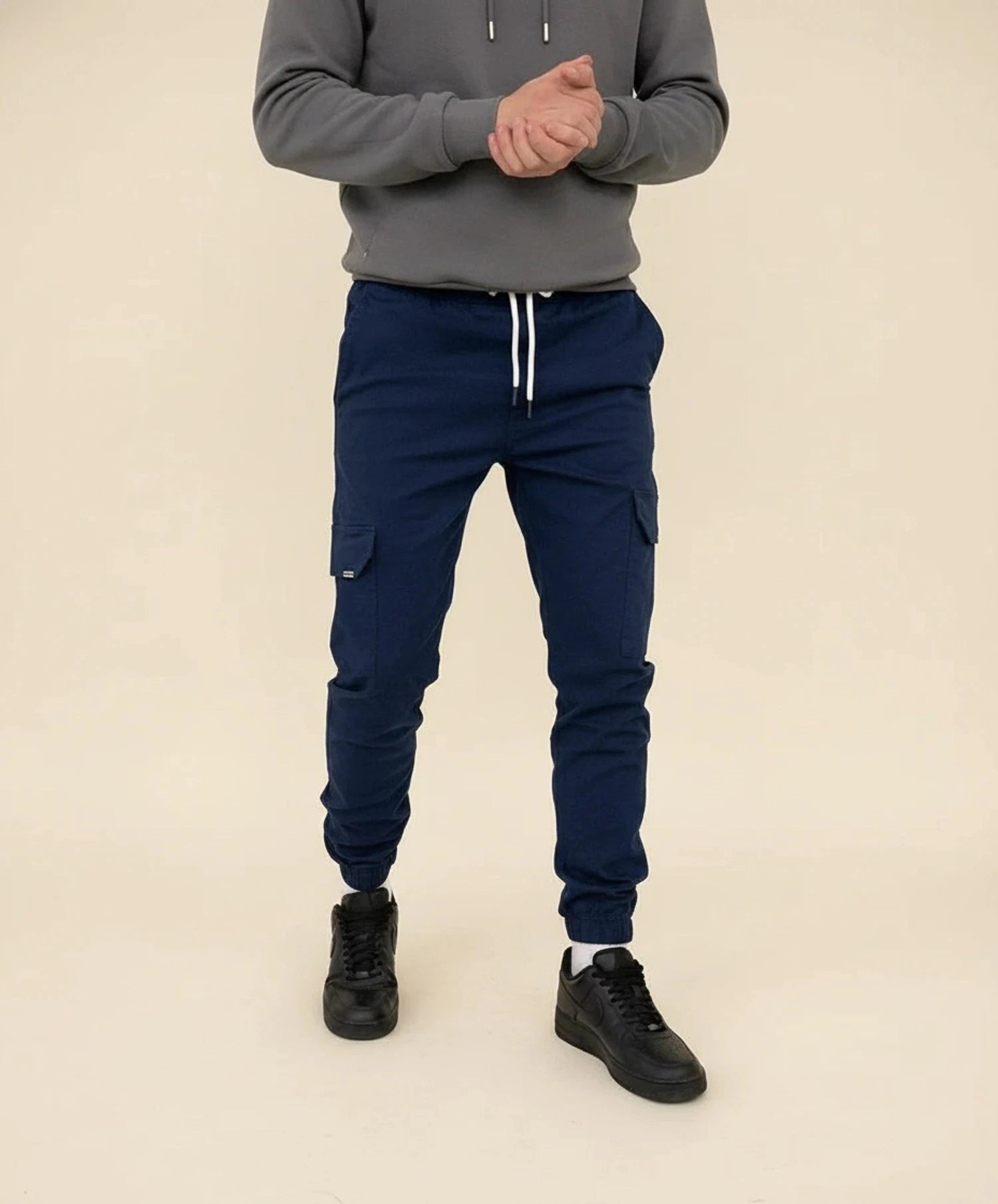 View of modern slim tapered cargo pants in olive green, featuring multiple pockets and a soft cotton blend fabric