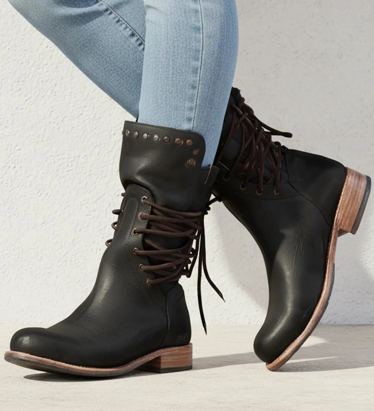 View of classic modern orthopedic boots in black leather, featuring a low heel and cushioned insole