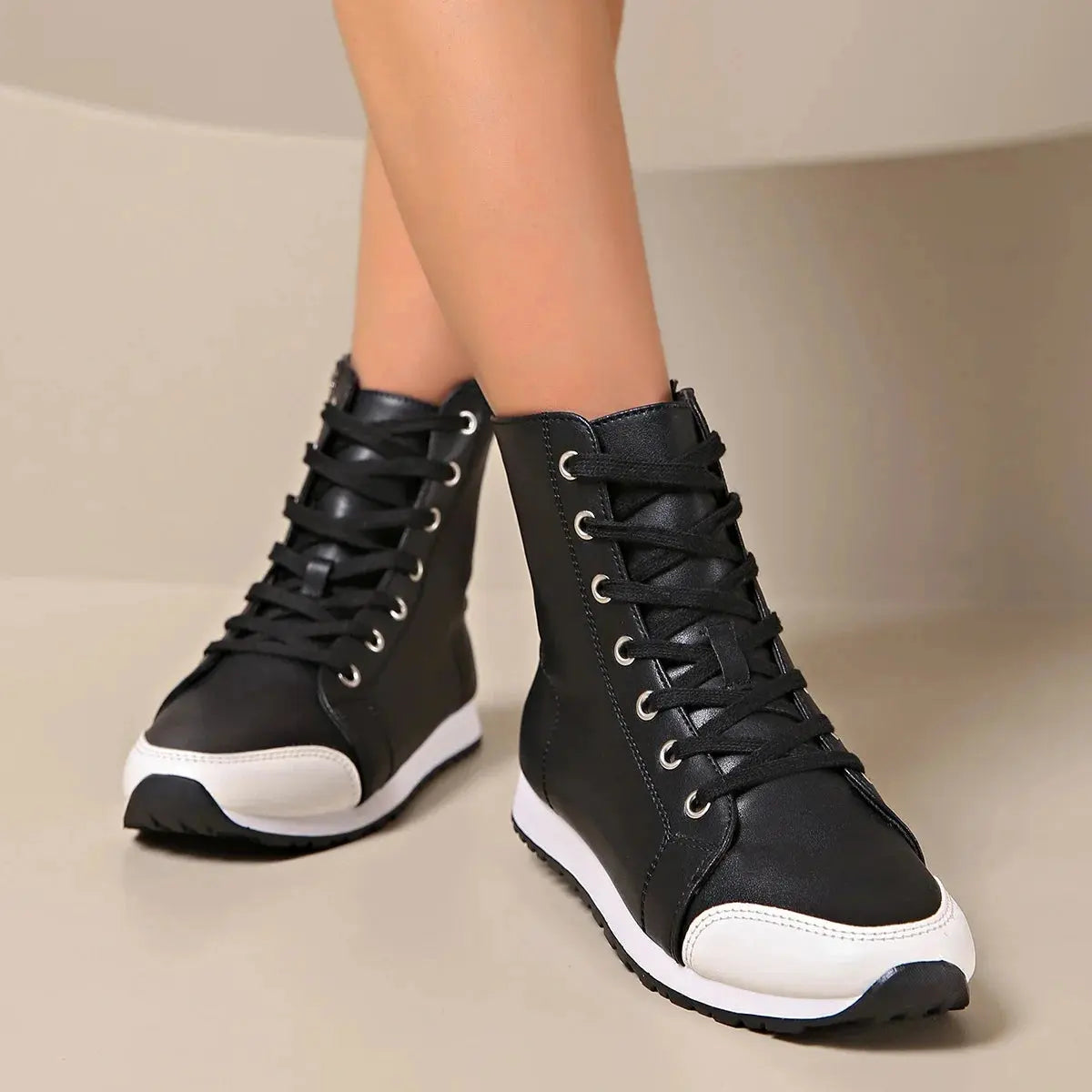 View of women's chic supportive sneakers in light gray mesh with white sole and cushioned collar