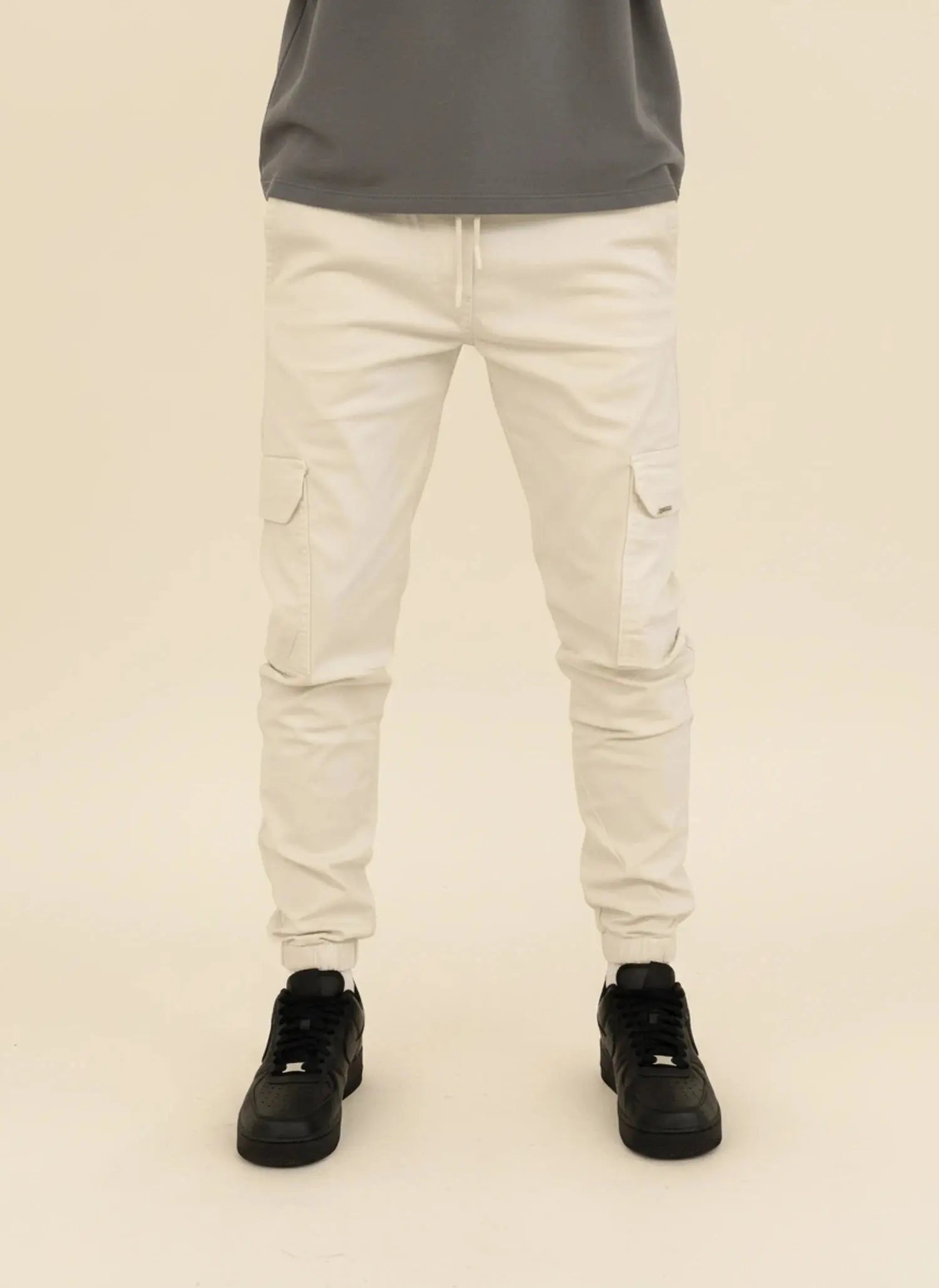 View of modern slim tapered cargo pants in olive green, featuring multiple pockets and a comfortable fit
