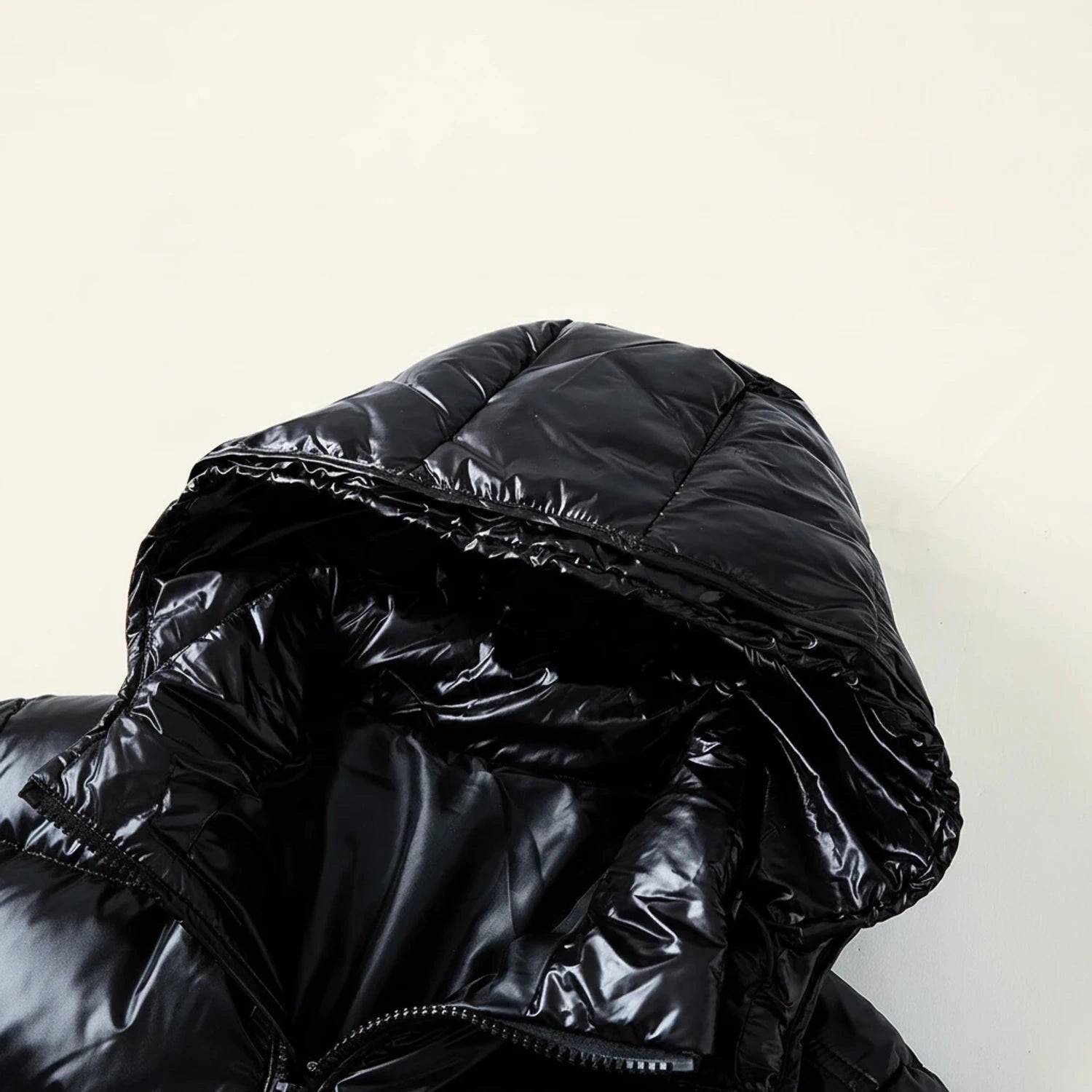 View of a stylish quilted winter puffer jacket in dark gray, featuring a high collar and zippered pockets