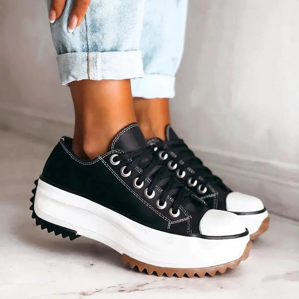 View of women's chic sneakers in soft gray fabric with white soles, featuring a lace up design and cushioned insole