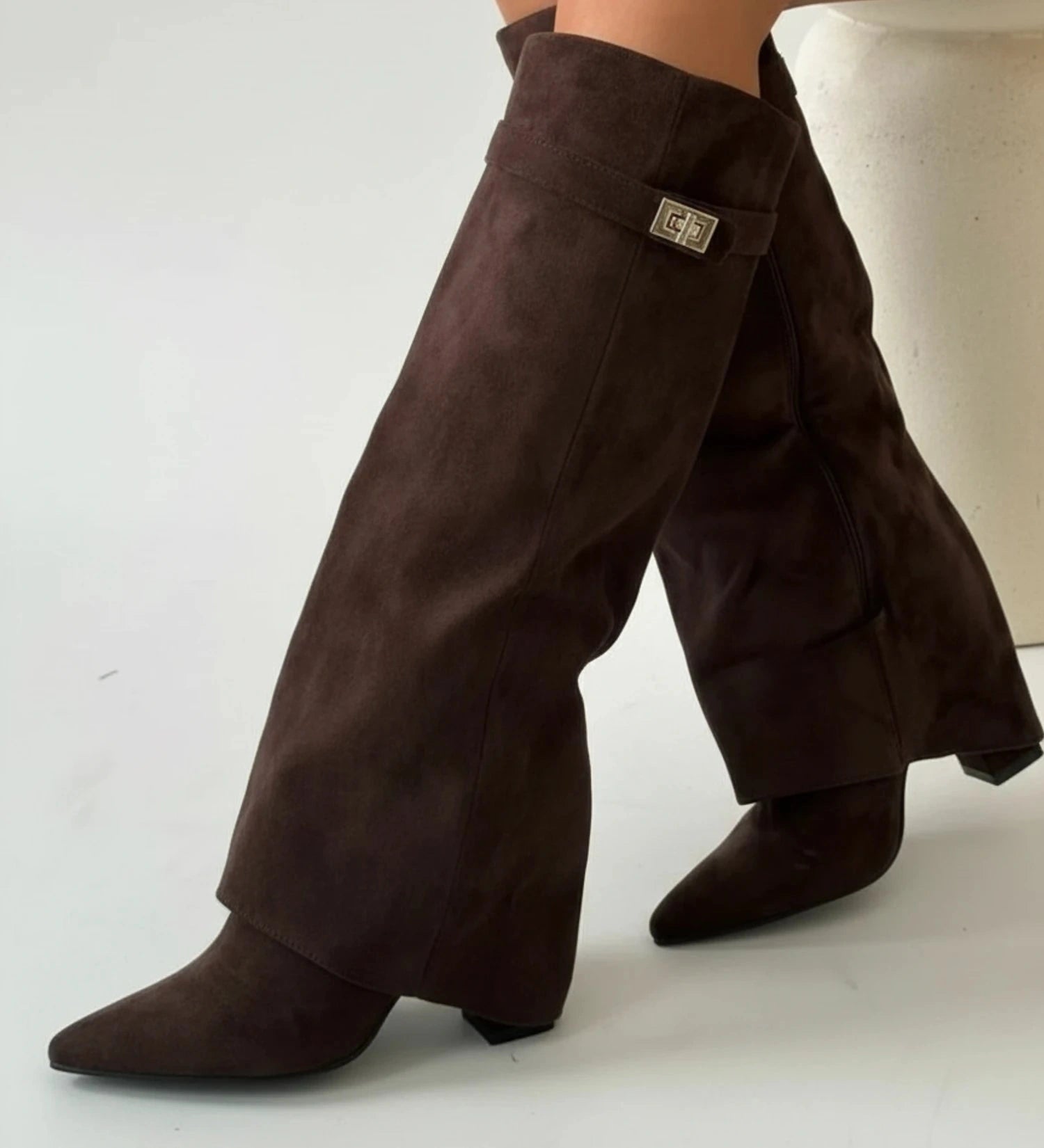 View of chic slouchy knee high boots in soft black suede, featuring a relaxed fit and stylish fold over top