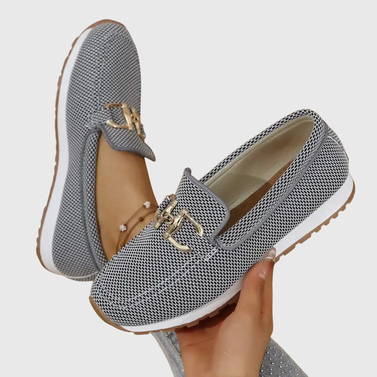 View of women's chic slip on loafers in soft beige leather, featuring a rounded toe and subtle stitching accents