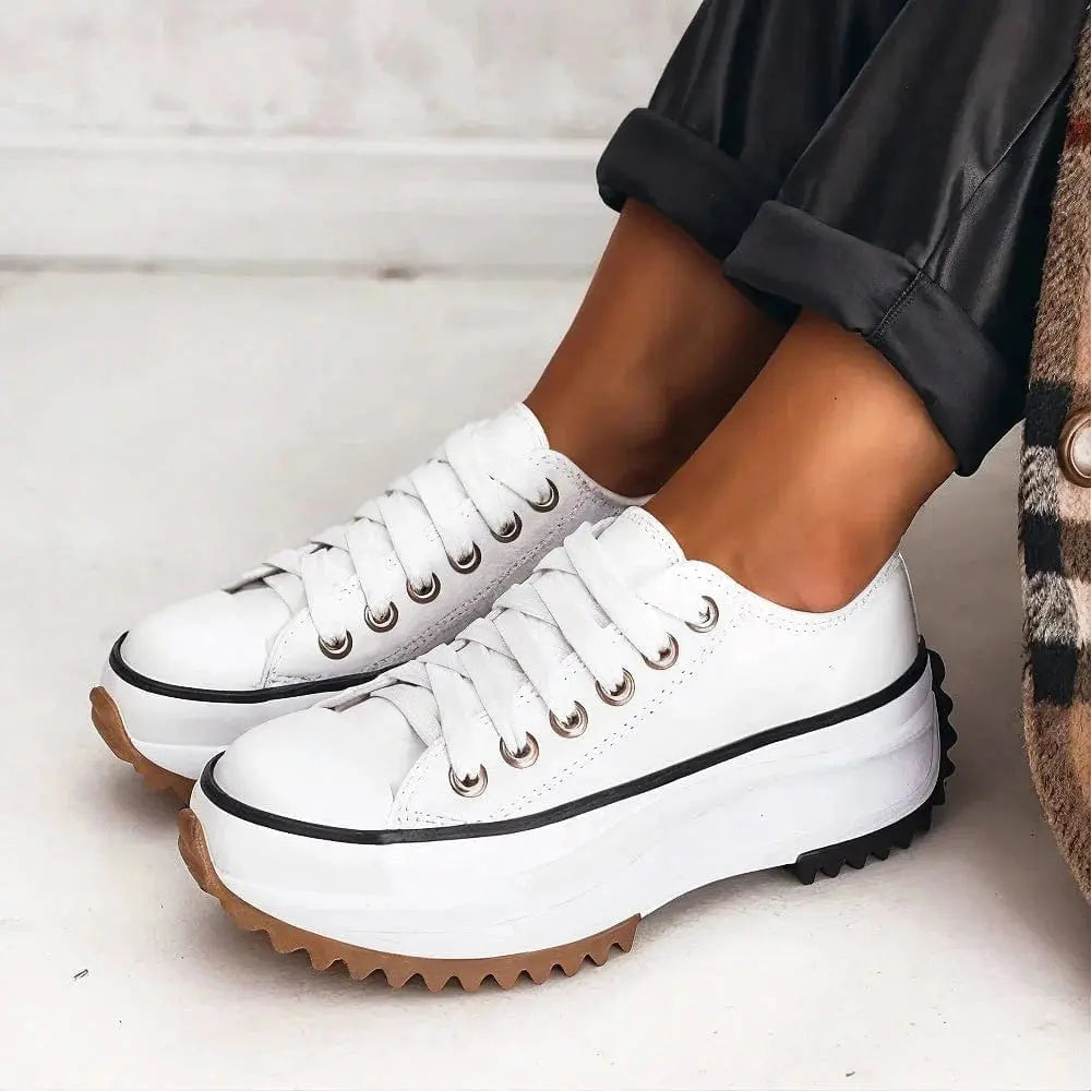 View of women's chic sneakers in light gray fabric with white sole and subtle stitching details