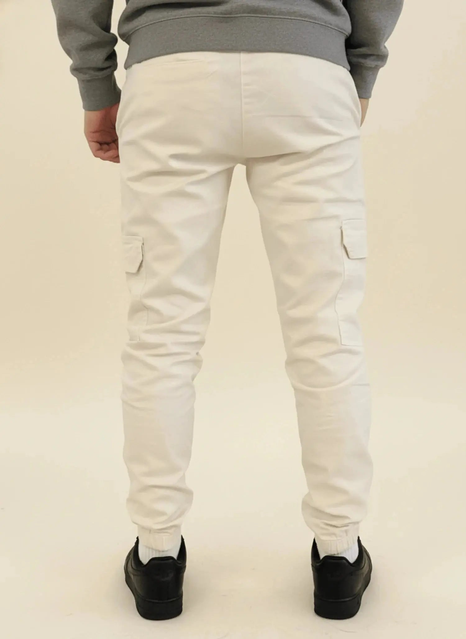 View of modern slim tapered cargo pants in olive green, featuring multiple pockets and a soft cotton blend material