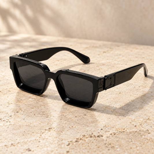 Small Black Charcoal sunglasses, complete pair on a warm neutral stone surface. — view 2
