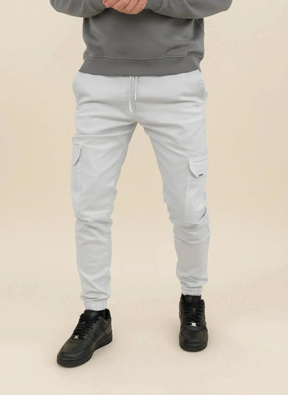 View of modern slim tapered cargo pants in olive green, featuring multiple pockets and a soft cotton blend material