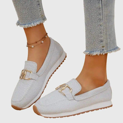 View of beige slip on loafers made from soft suede, featuring a sleek silhouette and subtle stitching accents