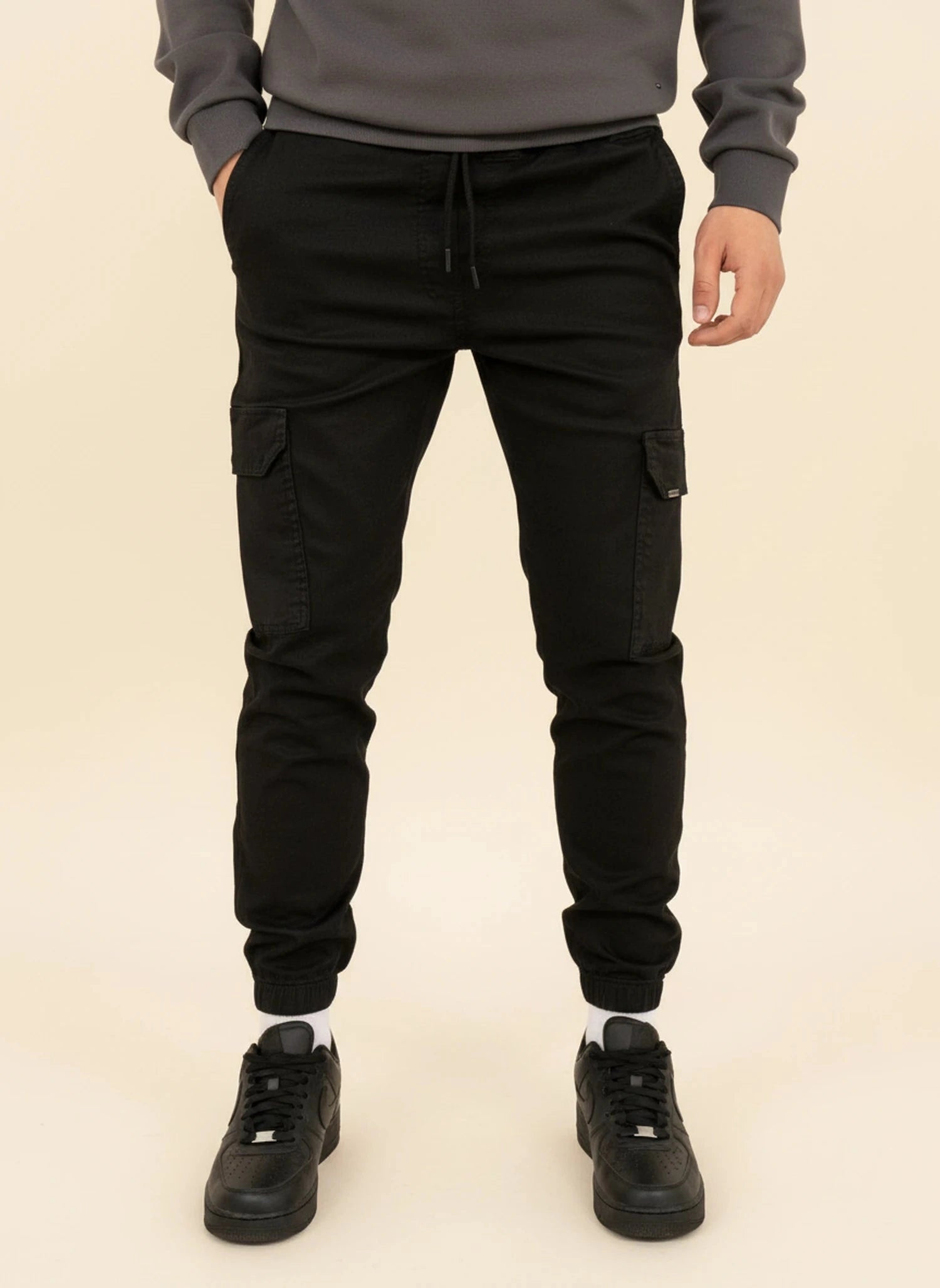 View of modern slim tapered cargo pants in olive green, made