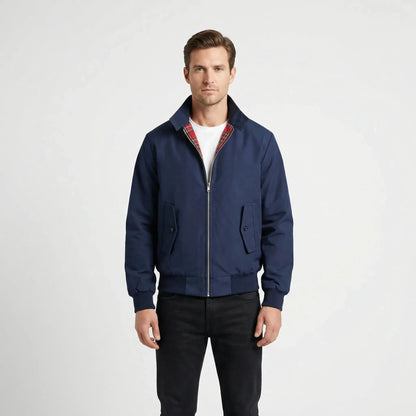 View of a dark gray winter jacket featuring a high collar, buttoned , and textured fabric