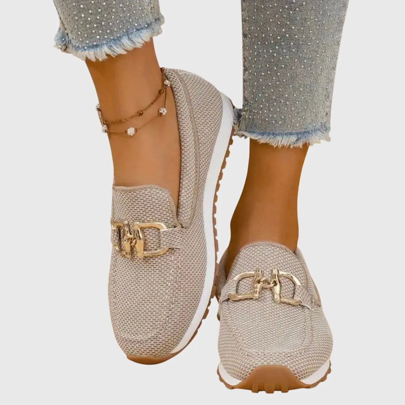 View of women's chic slip on loafers in soft beige leather with a sleek silhouette and minimalistic design