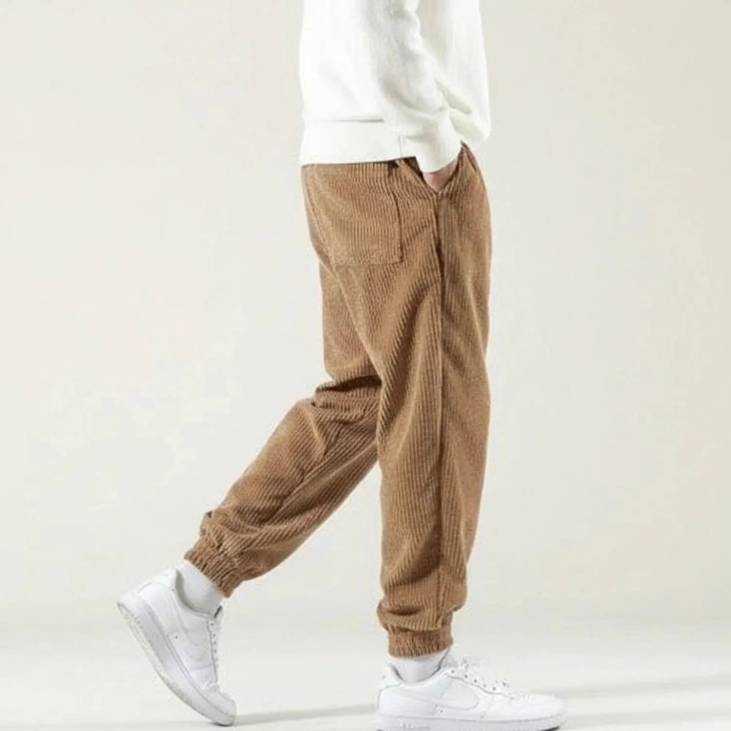 View of relaxed versatile jogger pants in charcoal gray, featuring an elastic waistband and pockets
