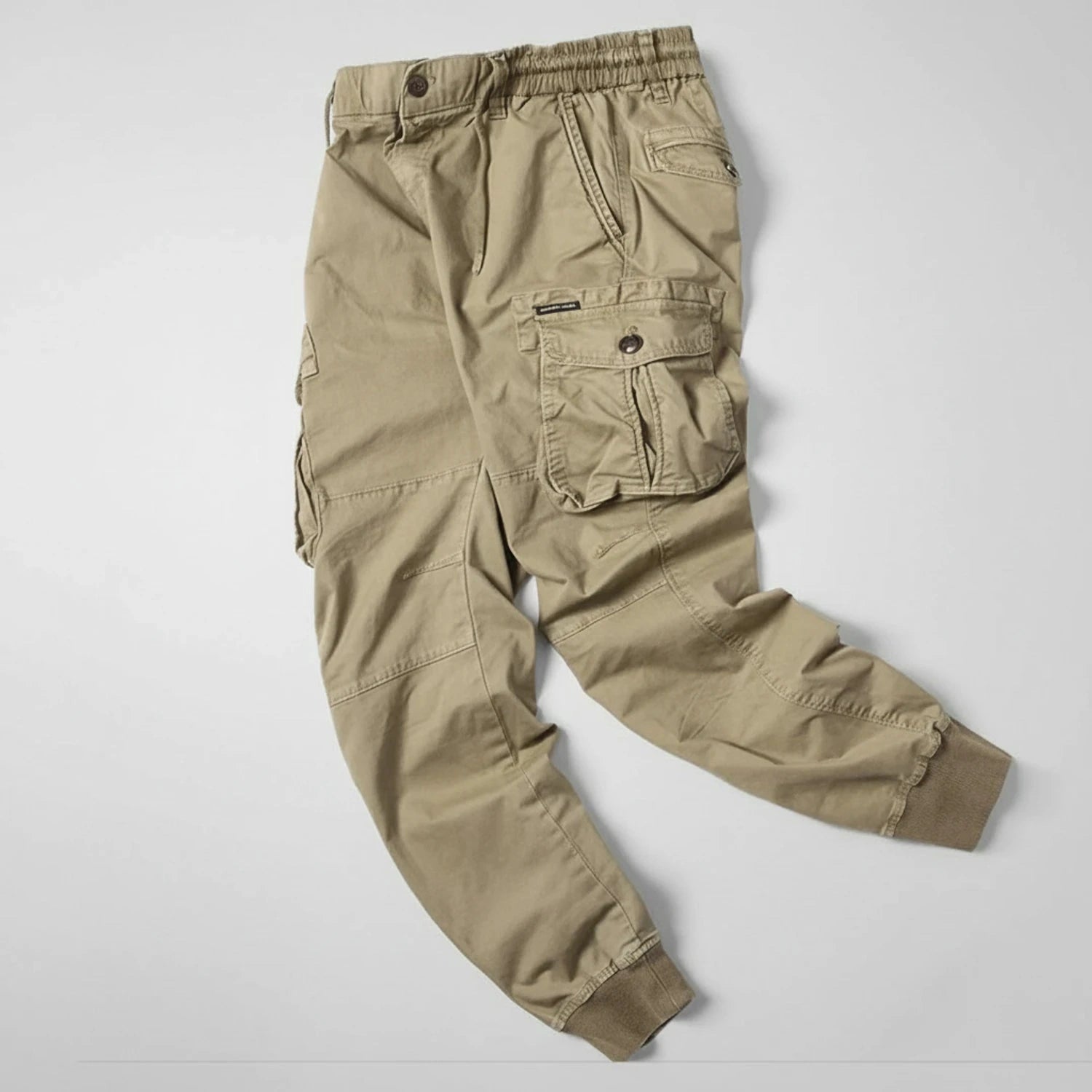 View of relaxed utility summer cargo jogger pants in light khaki, featuring multiple pockets and a comfortable fit