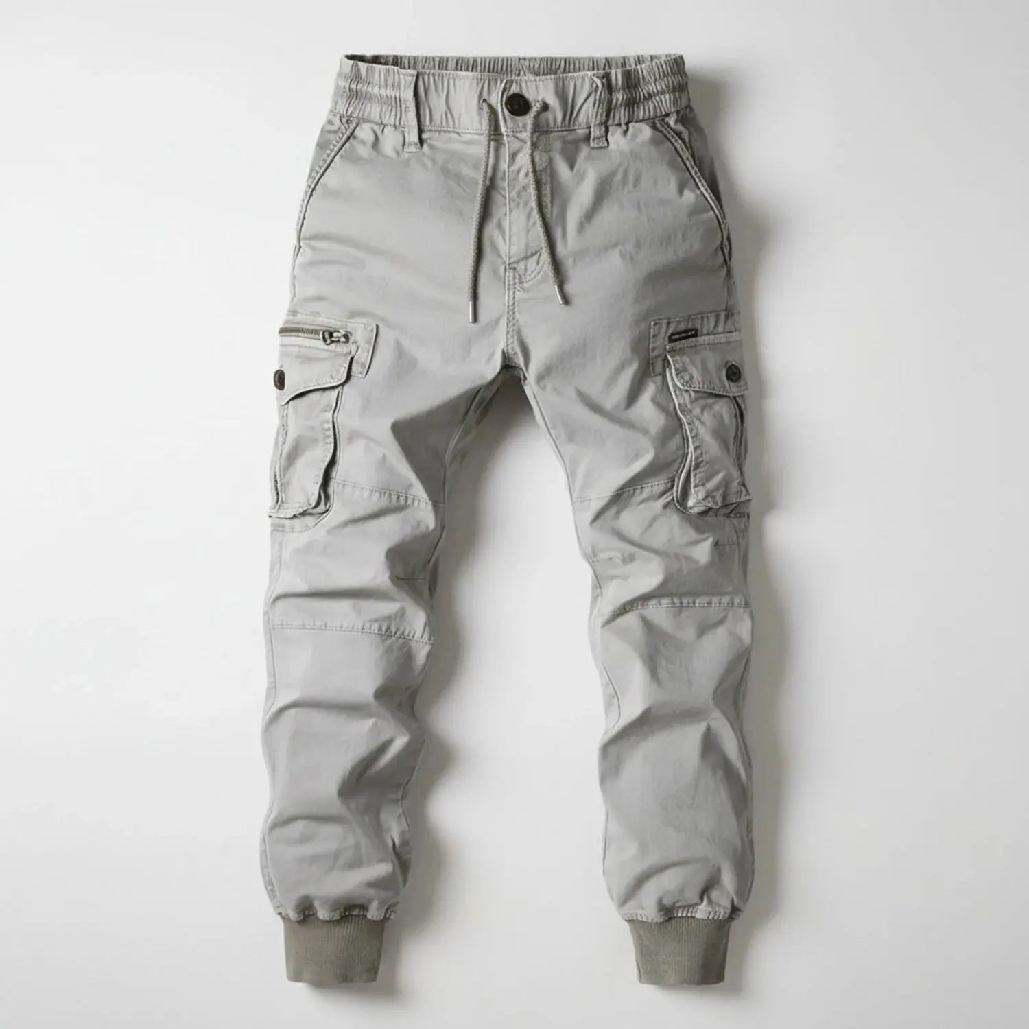 View of relaxed utility summer cargo jogger pants in olive green, featuring multiple pockets and a lightweight fabric