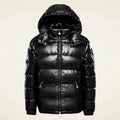 View of a stylish quilted winter puffer jacket in dark gray, featuring a high collar and zippered pockets