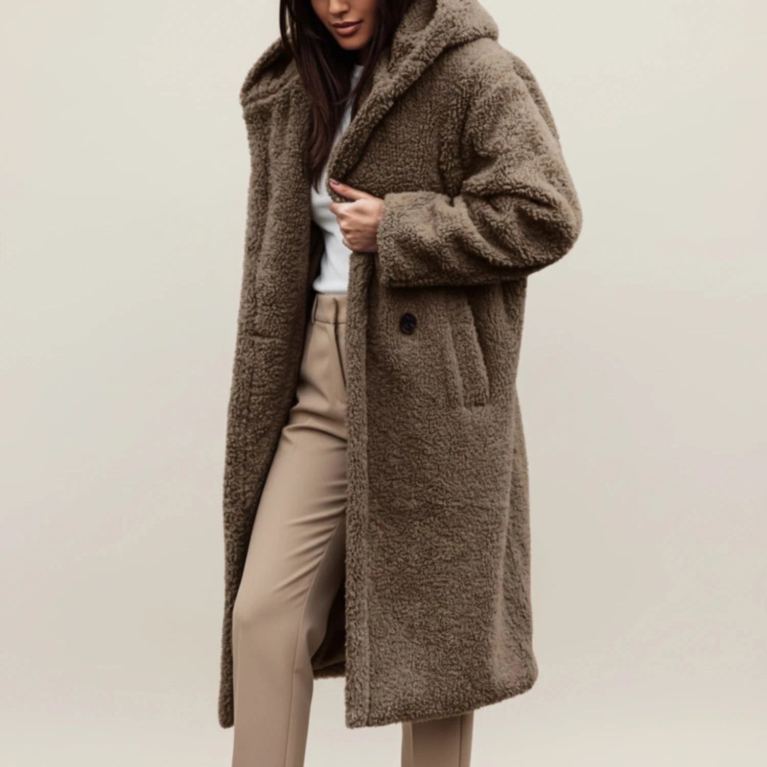 View of a cozy relaxed winter coat in soft gray fabric, featuring a hood and button closure