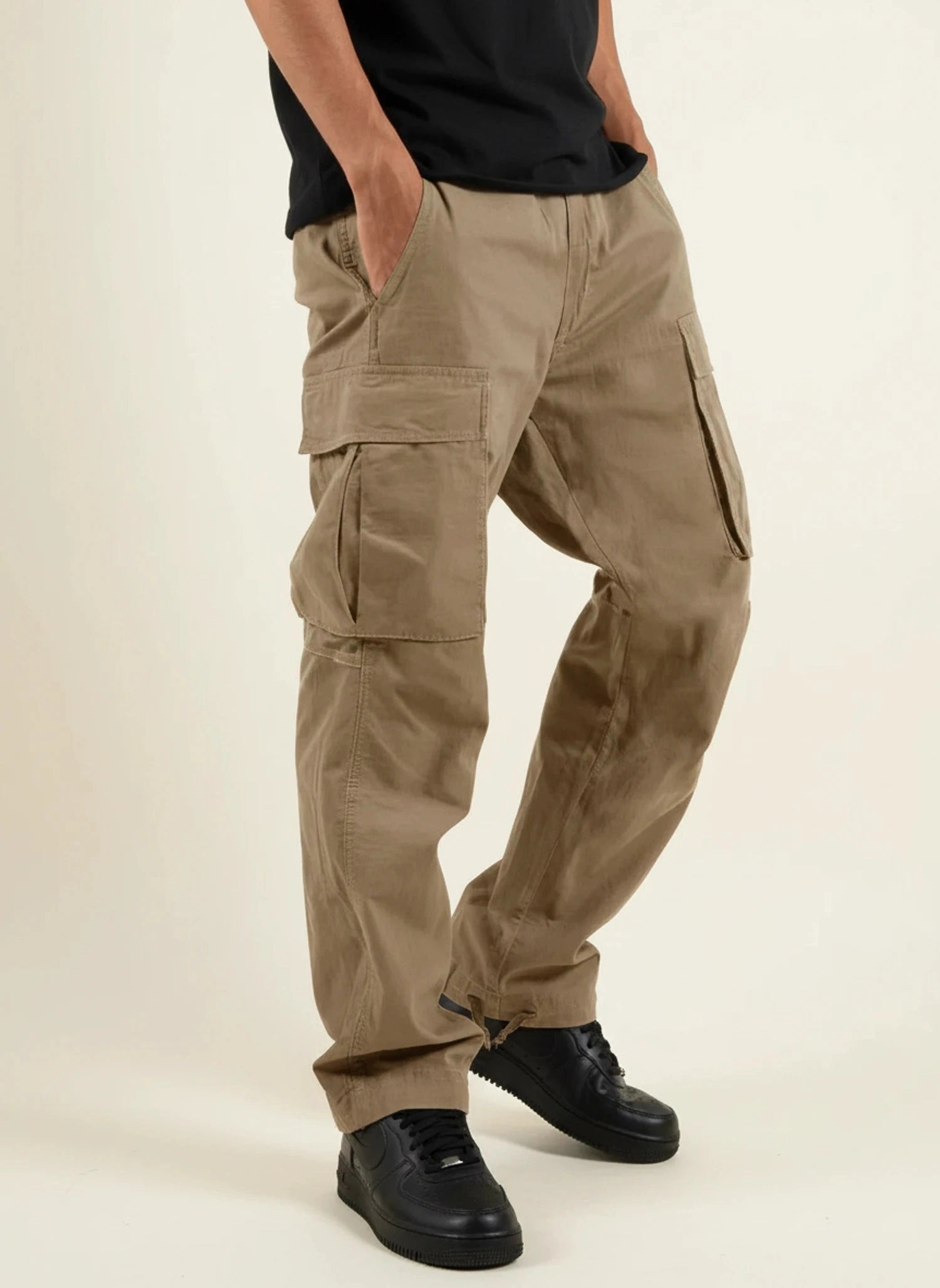 View of relaxed fit cargo pants in khaki, featuring multiple pockets and a comfortable waistband