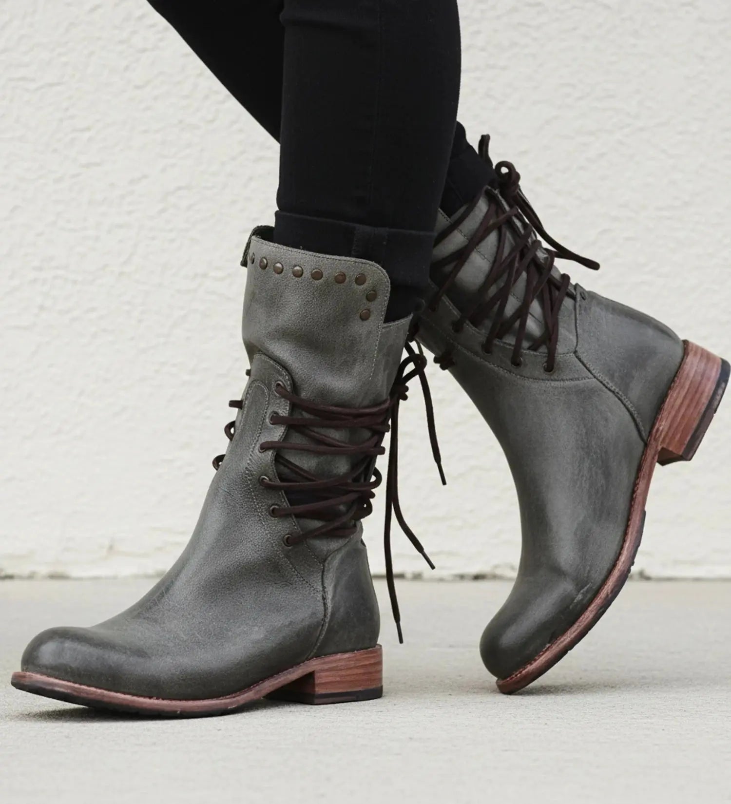 View of black leather orthopedic boots with a modern design, featuring a low heel and cushioned insole