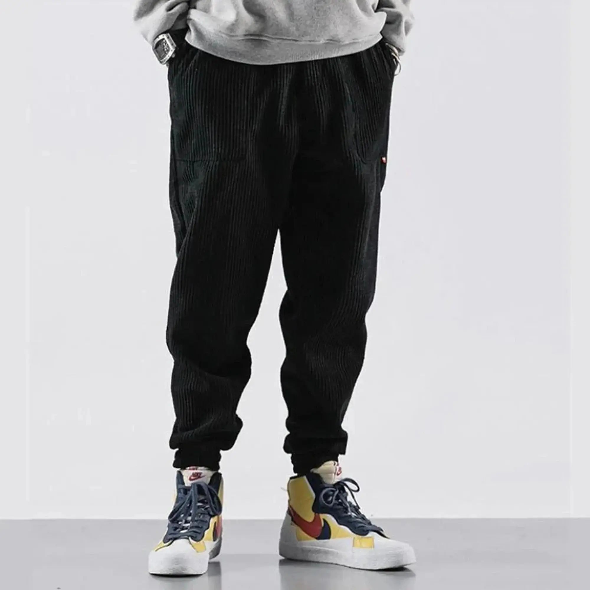 Black corduroy joggers with relaxed fit, worn
