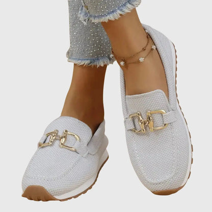 View of women's chic slip on loafers in soft beige suede, featuring a rounded toe and minimalistic design
