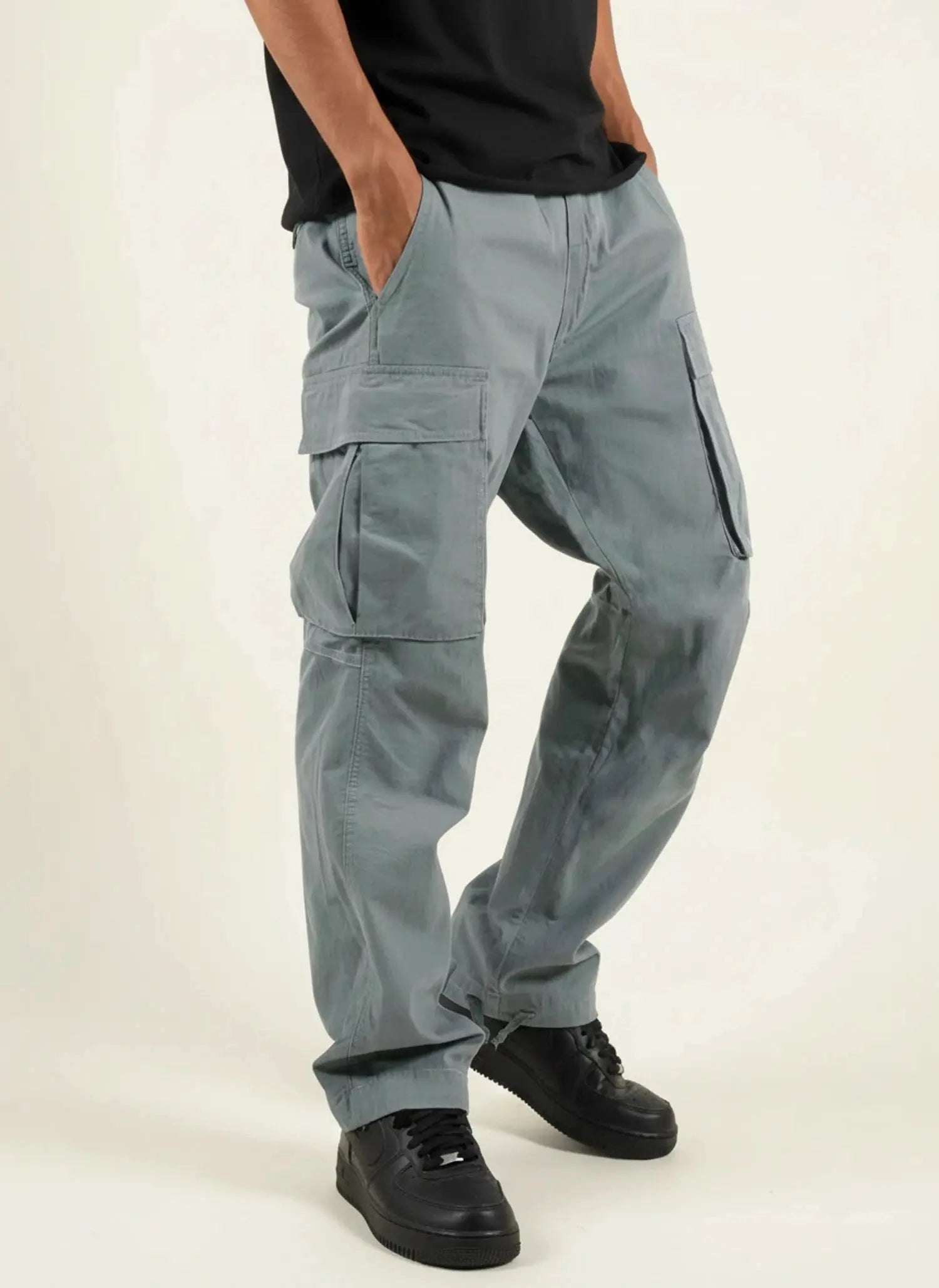 View of relaxed functional cargo pants in olive green, featuring multiple pockets and a soft cotton blend material