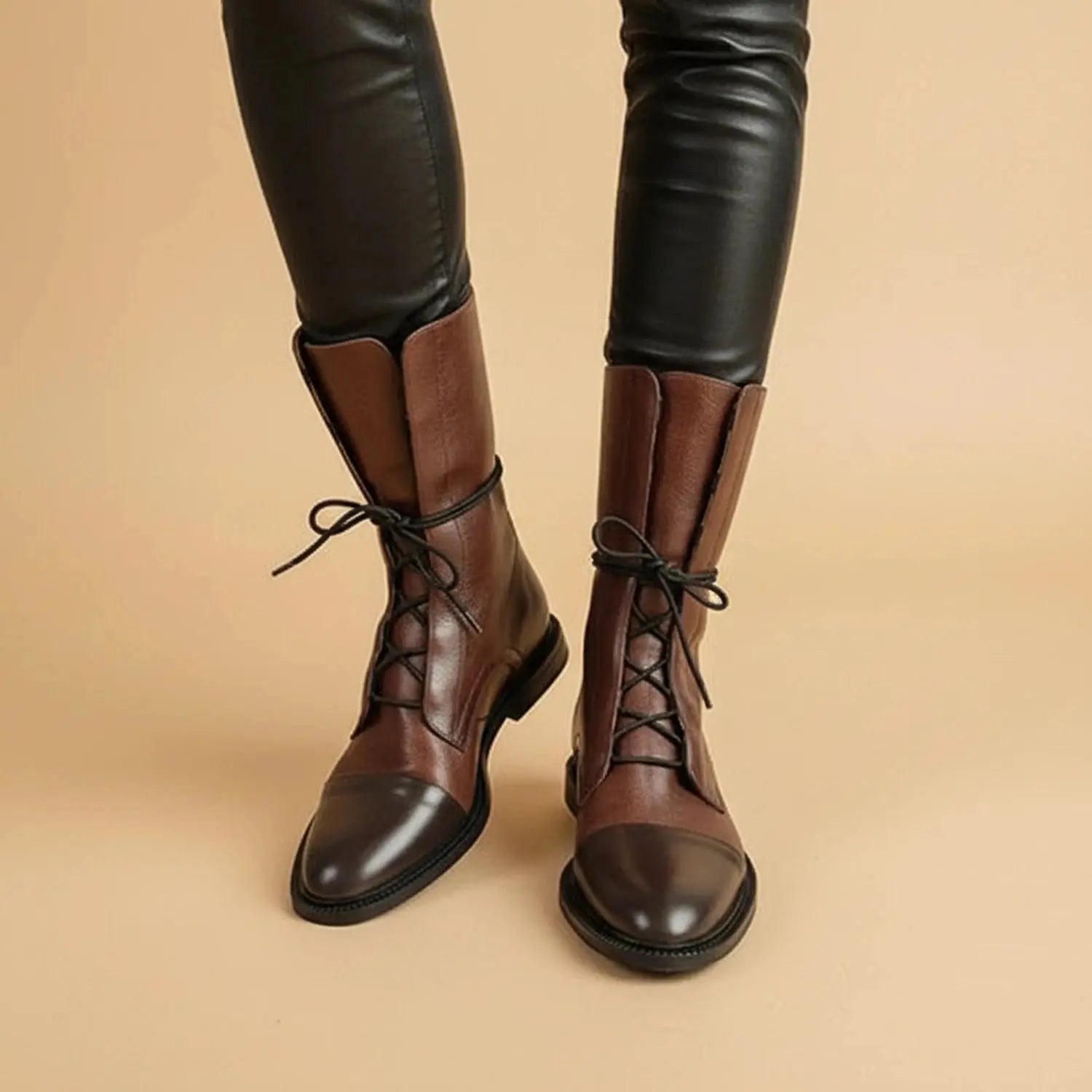 Black ankle boots with a sleek minimalist design, featuring a zipper and a smooth leather finish, view