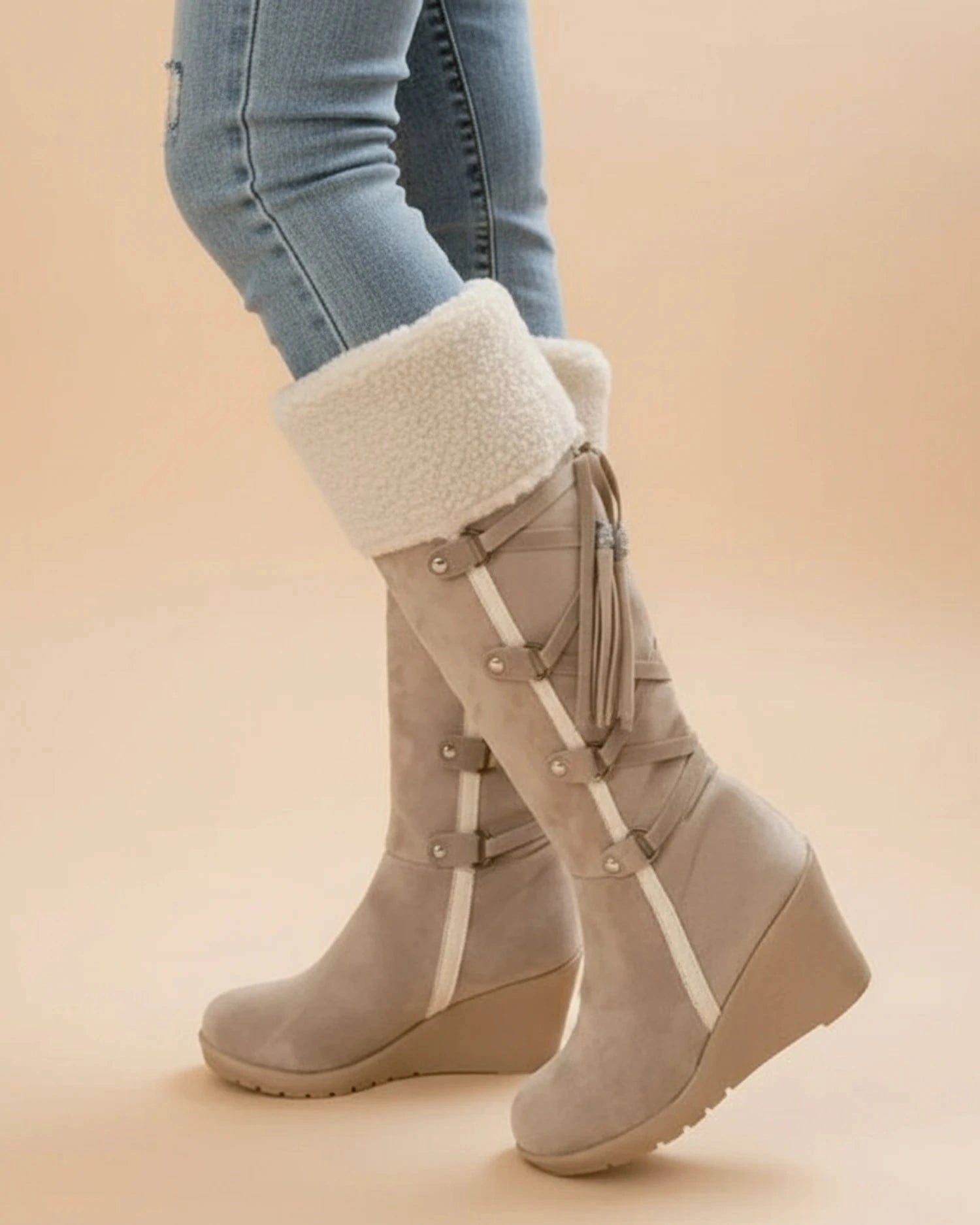 View of elegant women's winter boots in soft gray suede, featuring a cozy faux fur lining and sturdy rubber sole