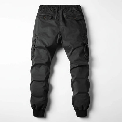View of relaxed utility summer cargo jogger pants in olive green, featuring multiple pockets and a comfortable waistband