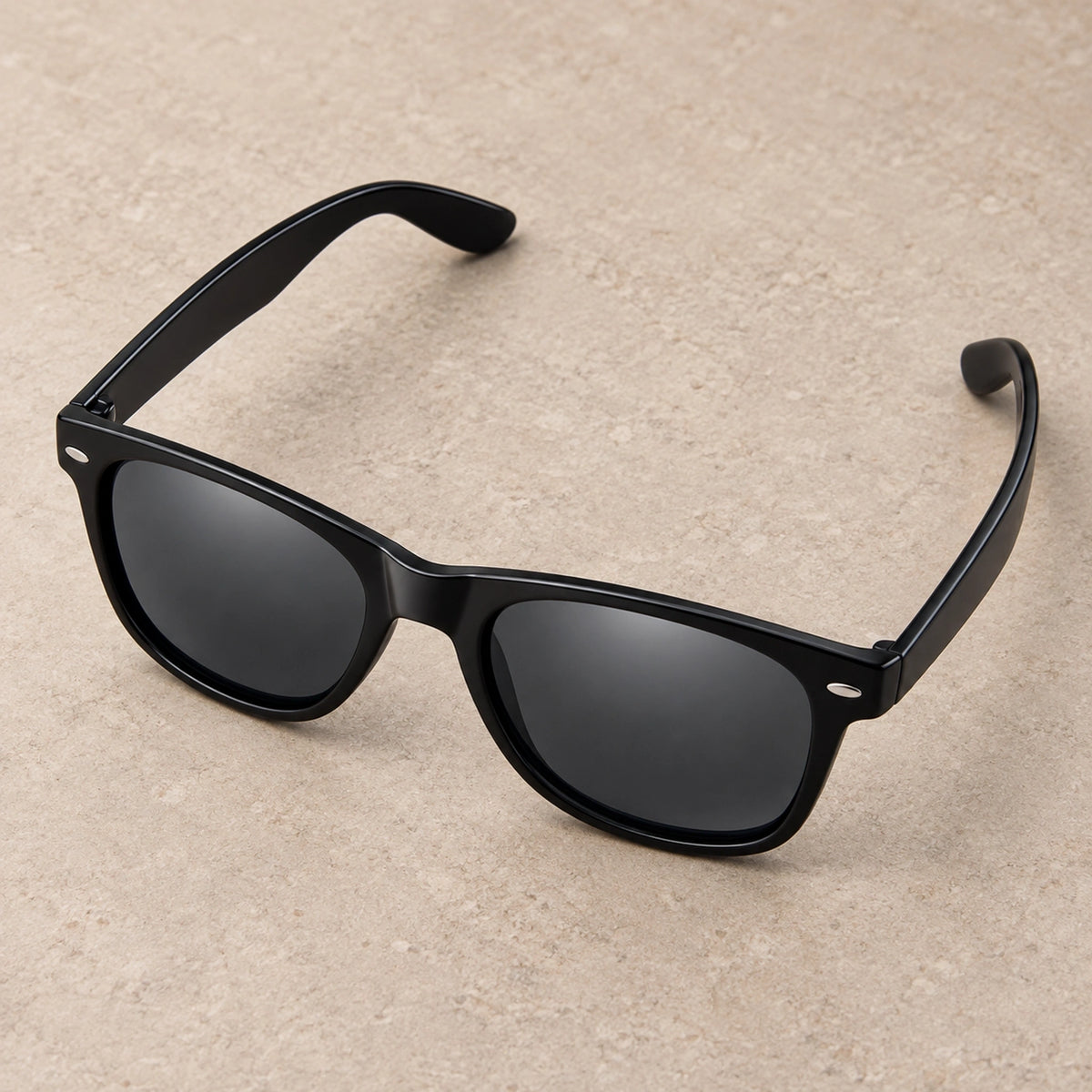 sunglasses — Black Charcoal eyewear, complete individual pair on warm neutral stone; product angle — view 4