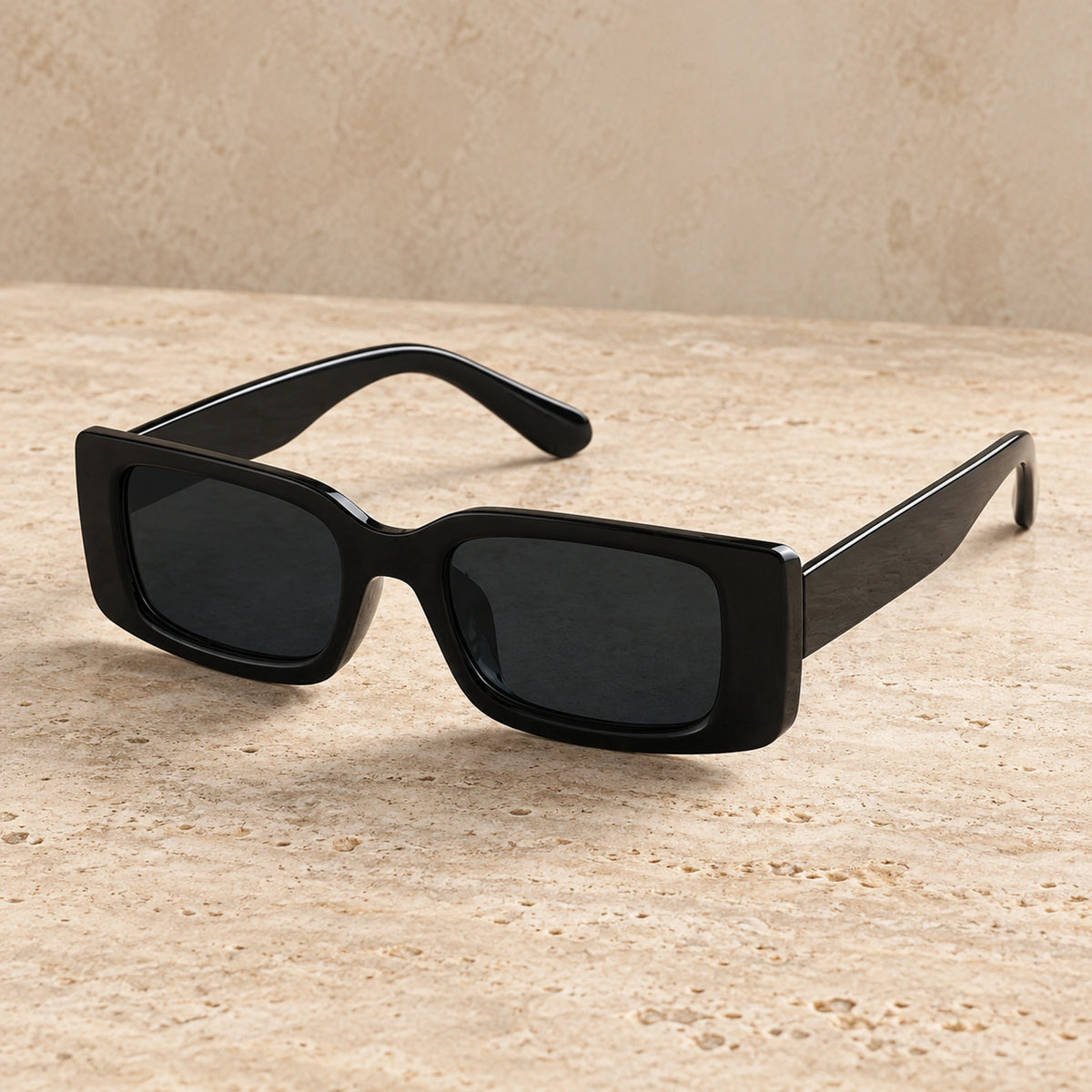 sunglasses — Black Charcoal eyewear, complete individual pair on warm neutral stone; front — view 2