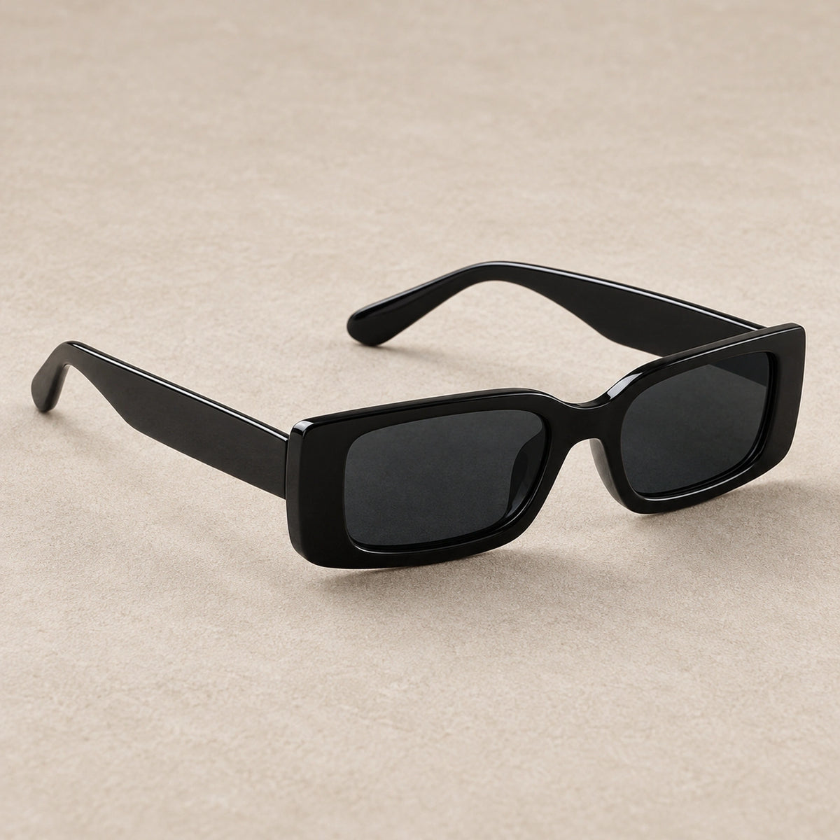 sunglasses — Black Charcoal eyewear, complete individual pair on warm neutral stone; product angle — view 3