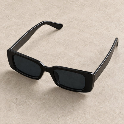 sunglasses — Black Charcoal eyewear, complete individual pair on warm neutral stone; product angle — view 4