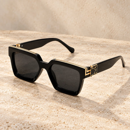 Medium Gold Black Charcoal sunglasses, complete pair on a warm neutral stone surface. — view 11