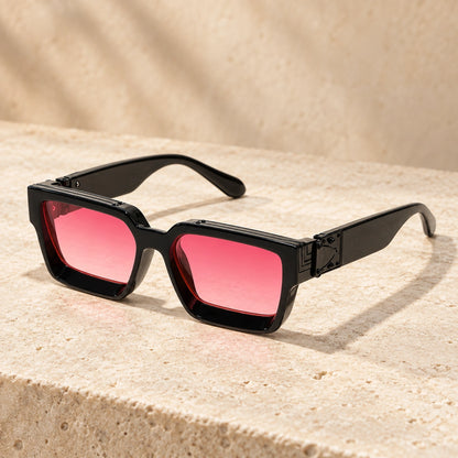 Small Black Pink Gradient sunglasses, complete pair on a warm neutral stone surface. — view 12
