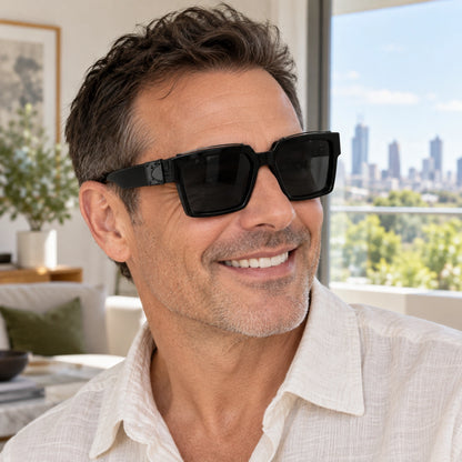 Large Black Charcoal sunglasses worn by an adult model, angle. — view 16