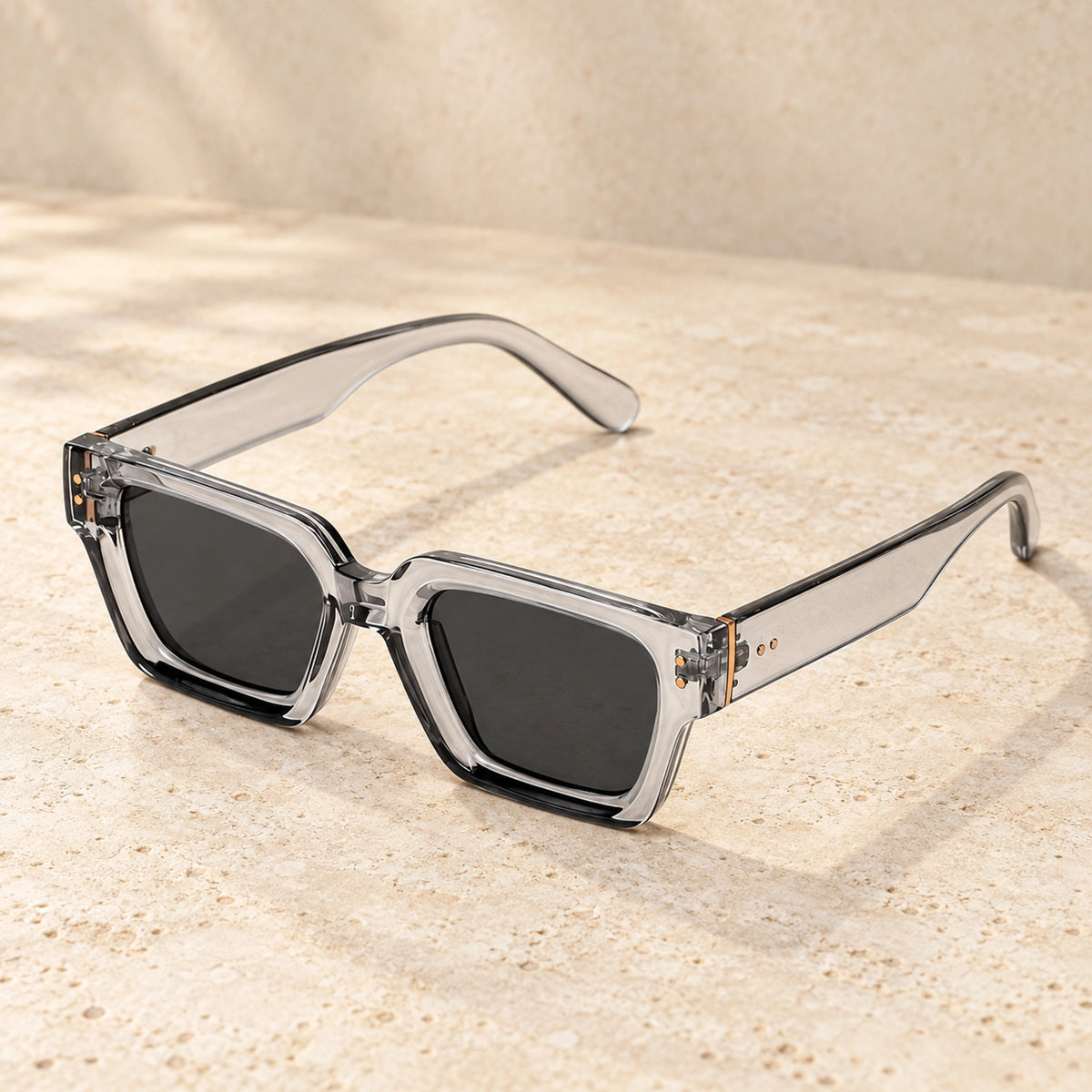 Clear Grey sunglasses, complete pair on a warm neutral stone surface. — view 3