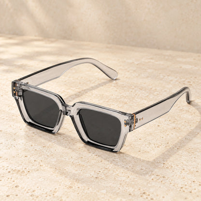 Clear Grey sunglasses, complete pair on a warm neutral stone surface. — view 3