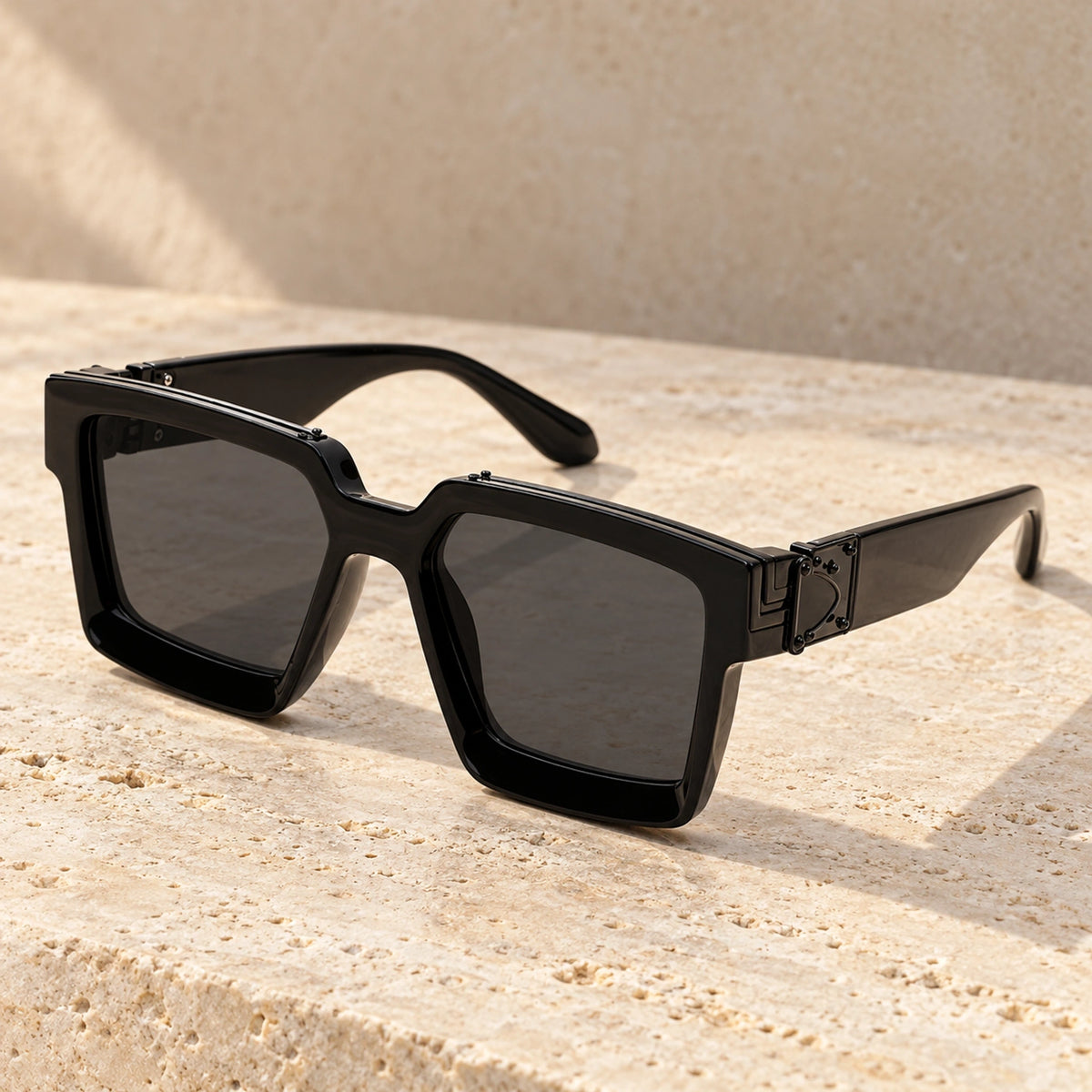 Large Black Charcoal sunglasses, complete pair on a warm neutral stone surface. — view 4