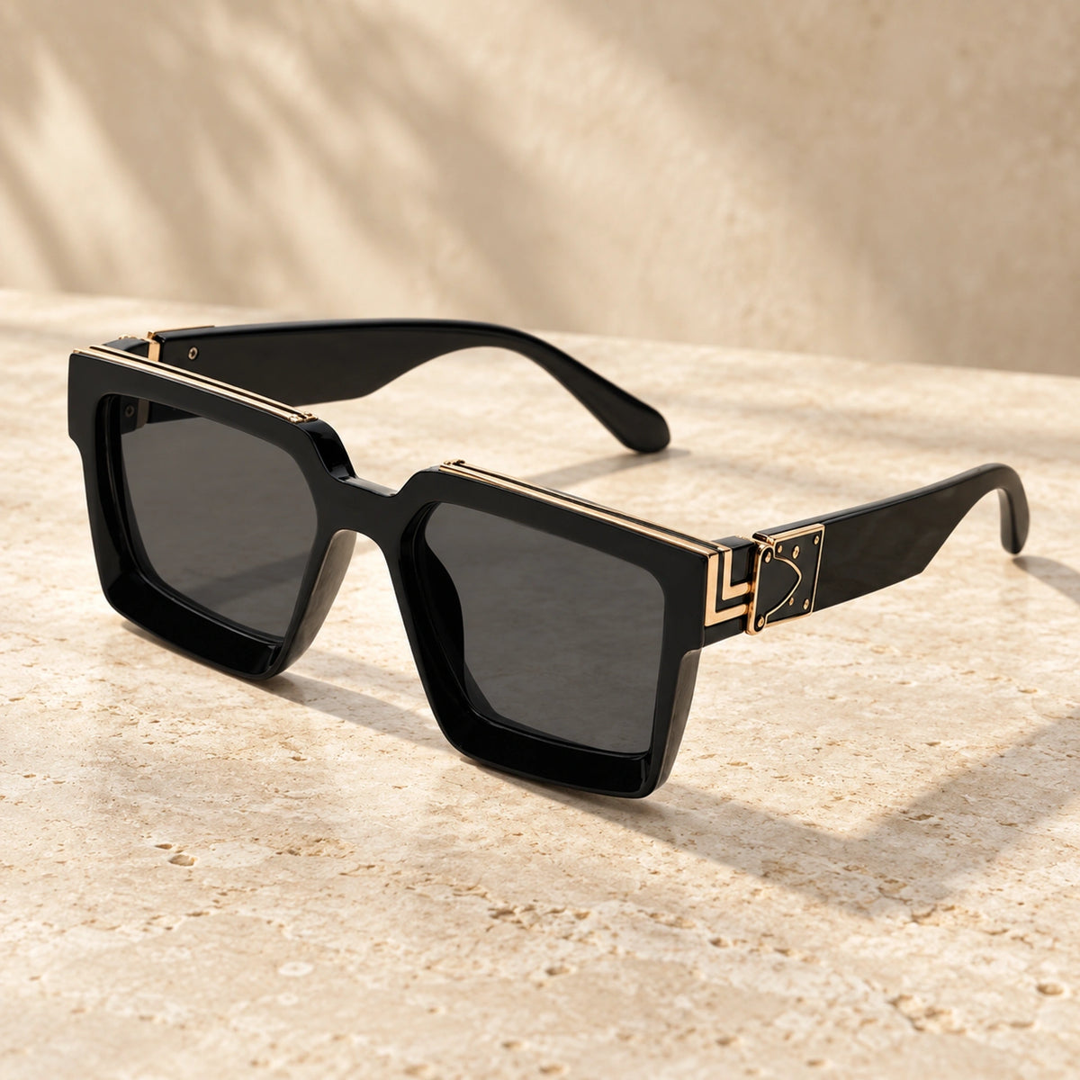 Large Gold Black Charcoal sunglasses, complete pair on a warm neutral stone surface. — view 8